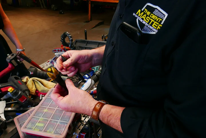 The Dent Master technician working with specialist tools